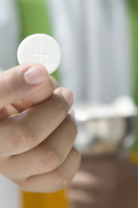 Priest Holding Communion Wafer --- Image by © Royalty-Free/Corbis
